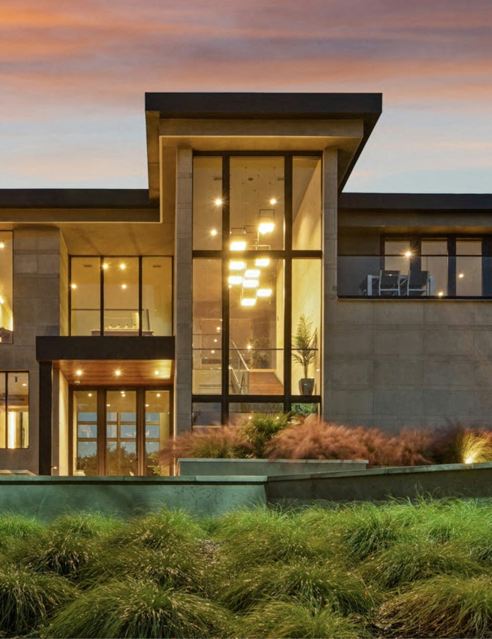 Modern construction project with double-height glass, structural engineering precision and warm interior lighting